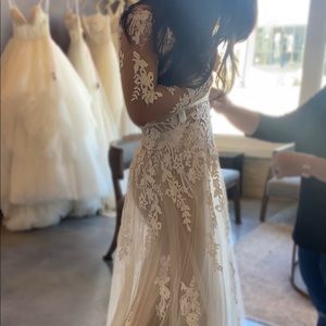 Lillian West long sleeve A-line wedding dress. Illusion button down back.